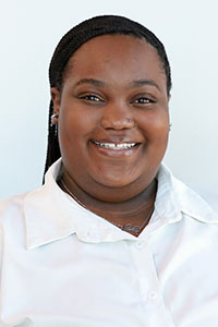 Black woman with braids wearing a white shirt