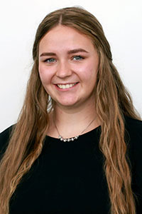 woman with light brown hair wearing a black shirt