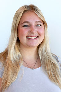 woman with blonde hair wearing a white shirt