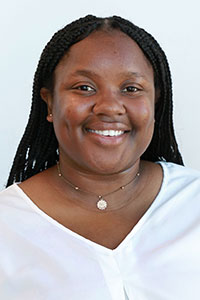 Black woman with braids wearing a white shirt