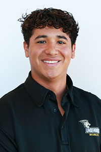 Man with olive skin wearing a Lindenwood polo