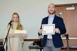 Cody Copeland is awarded First Place in his Poster Group at the Social Science Student Symposium (November 10, 2018) by Assistant Dean of the School of Sciences, Dr. Billi Patzius.